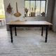 Oak farmhouse table with turned black legs.