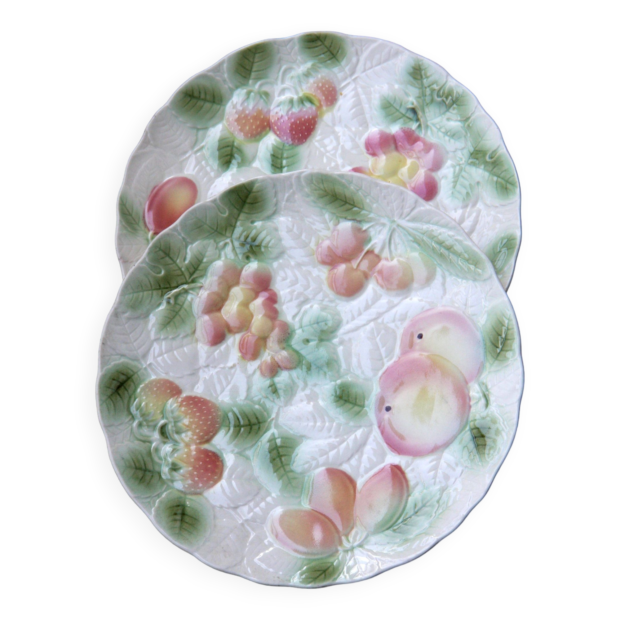 Two slip plates decorated with fruit.