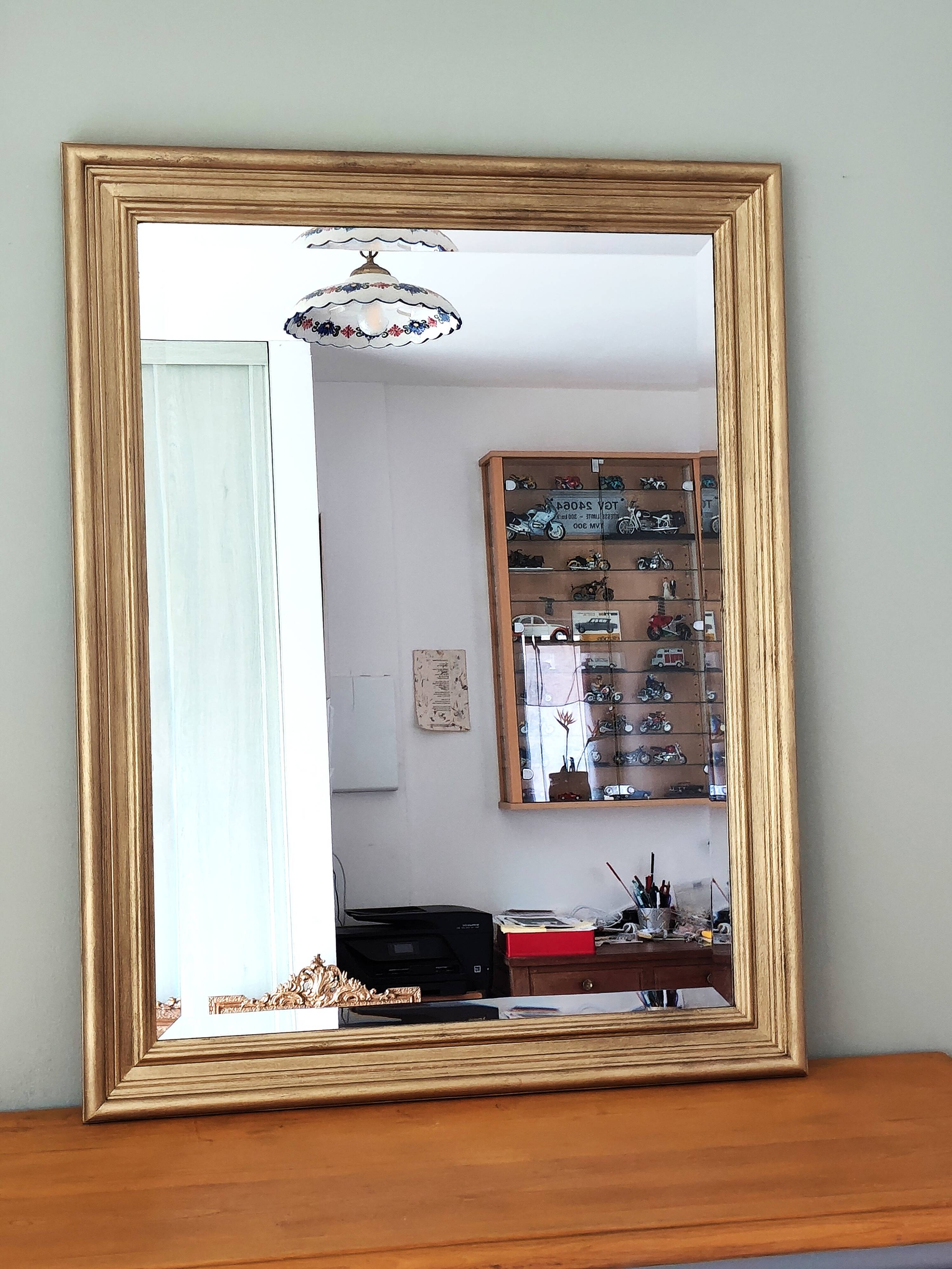 Large gold-framed mirror with bevelled glass.