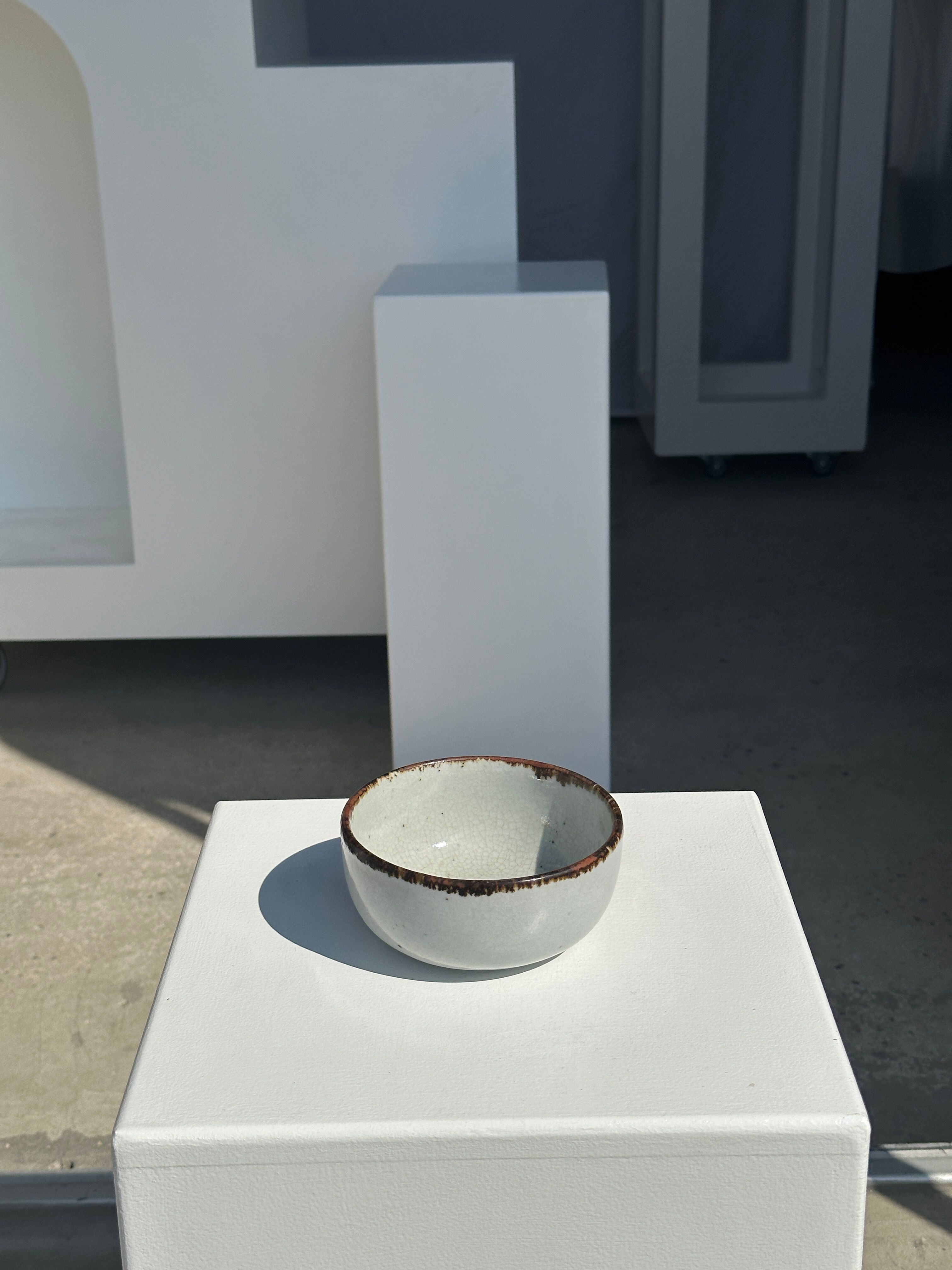 Small white glazed ceramic bowl black edges