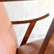 Vintage armchair from the 1950s in cognac leather and dark wood — modernist lounge chair.