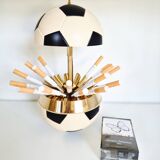 Vintage cigarette dispenser in the shape of a football.