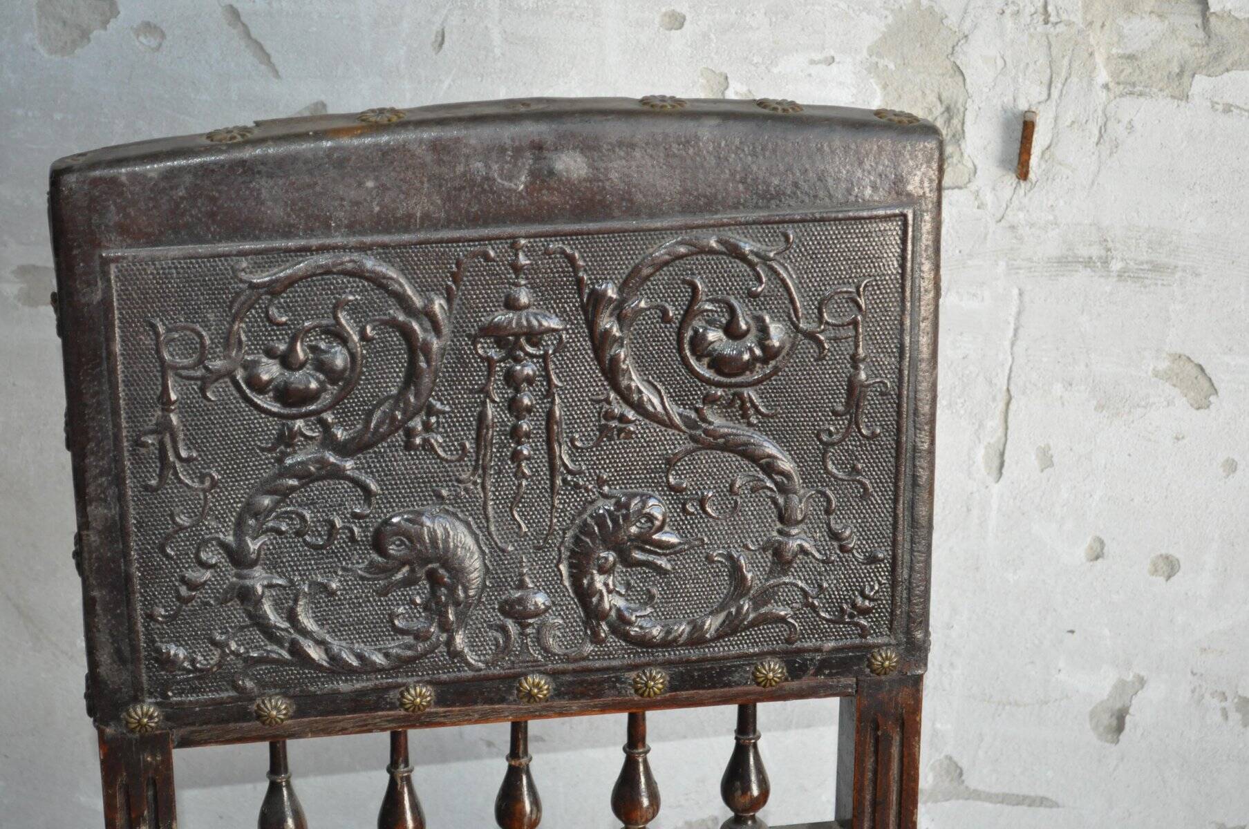 Pair of antique wooden and brown leather dining chairs, brass studs.