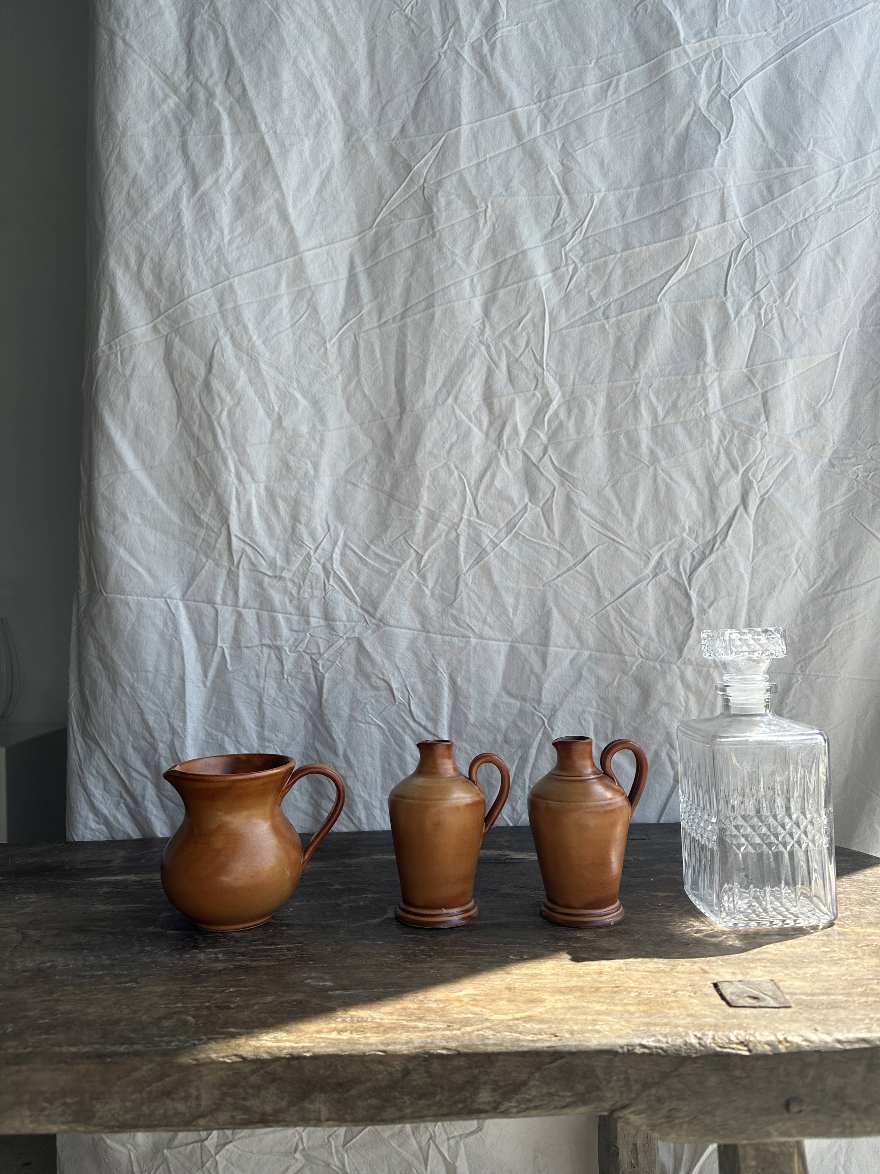 Pair of mini orange stoneware pitchers