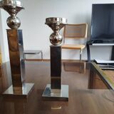 Pair of designer candlesticks in chromed metal.