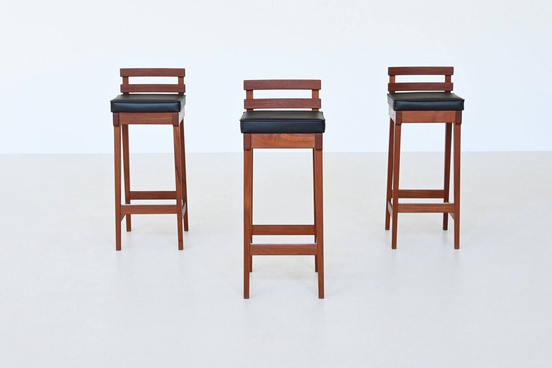 Erik Buck set of three bar stools in teak and leather Dyrlund Denmark 1960