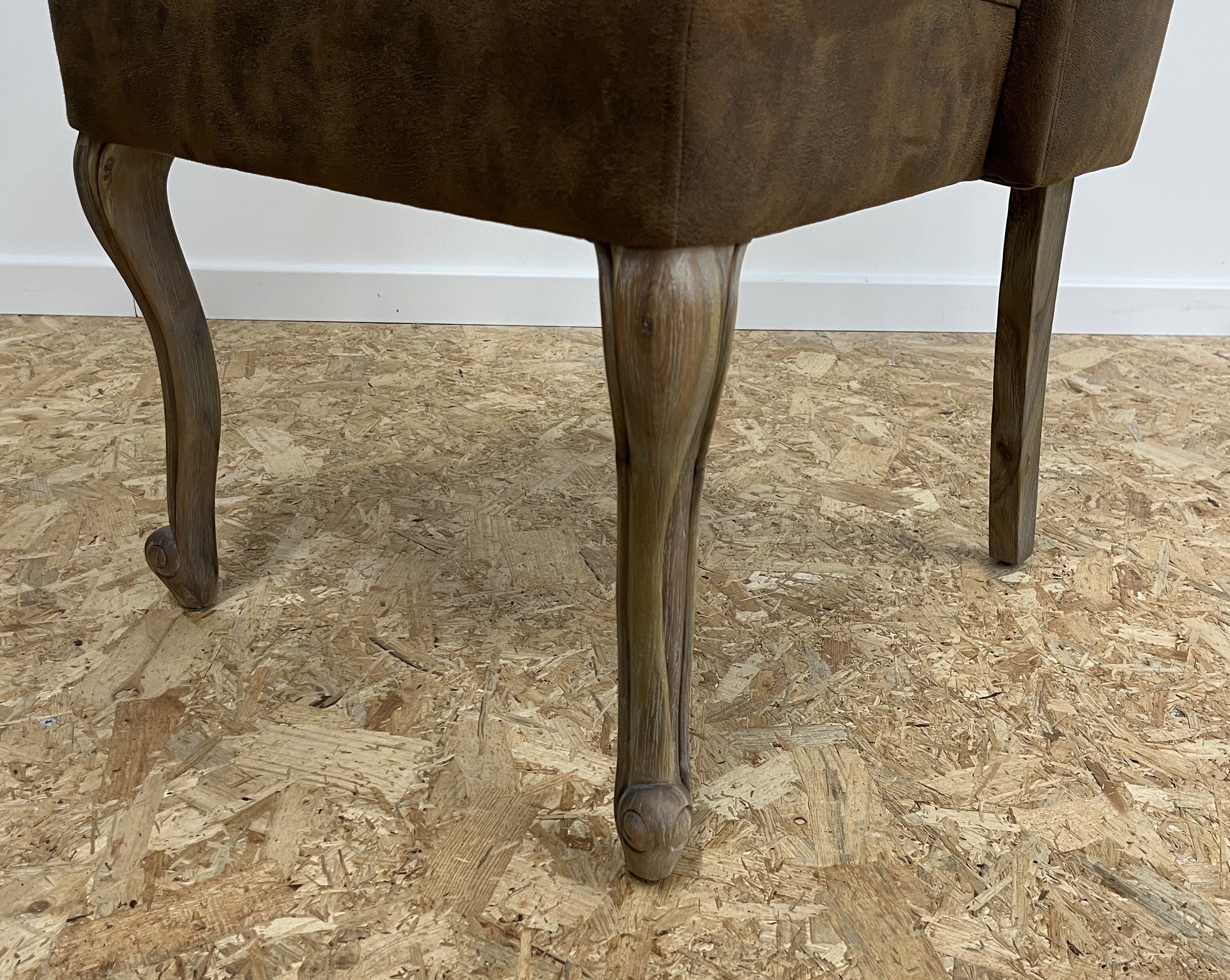 Upholstered armchair in brown imitation leather