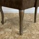 Upholstered armchair in brown imitation leather