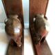 Art Deco bookends wooden elephants and bones on wooden terrace, book shape