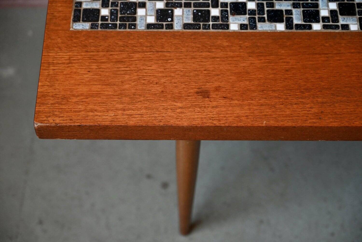 1970s coffee table with a tapered teak base and ceramic mosaic.