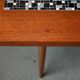 1970s coffee table with a tapered teak base and ceramic mosaic.