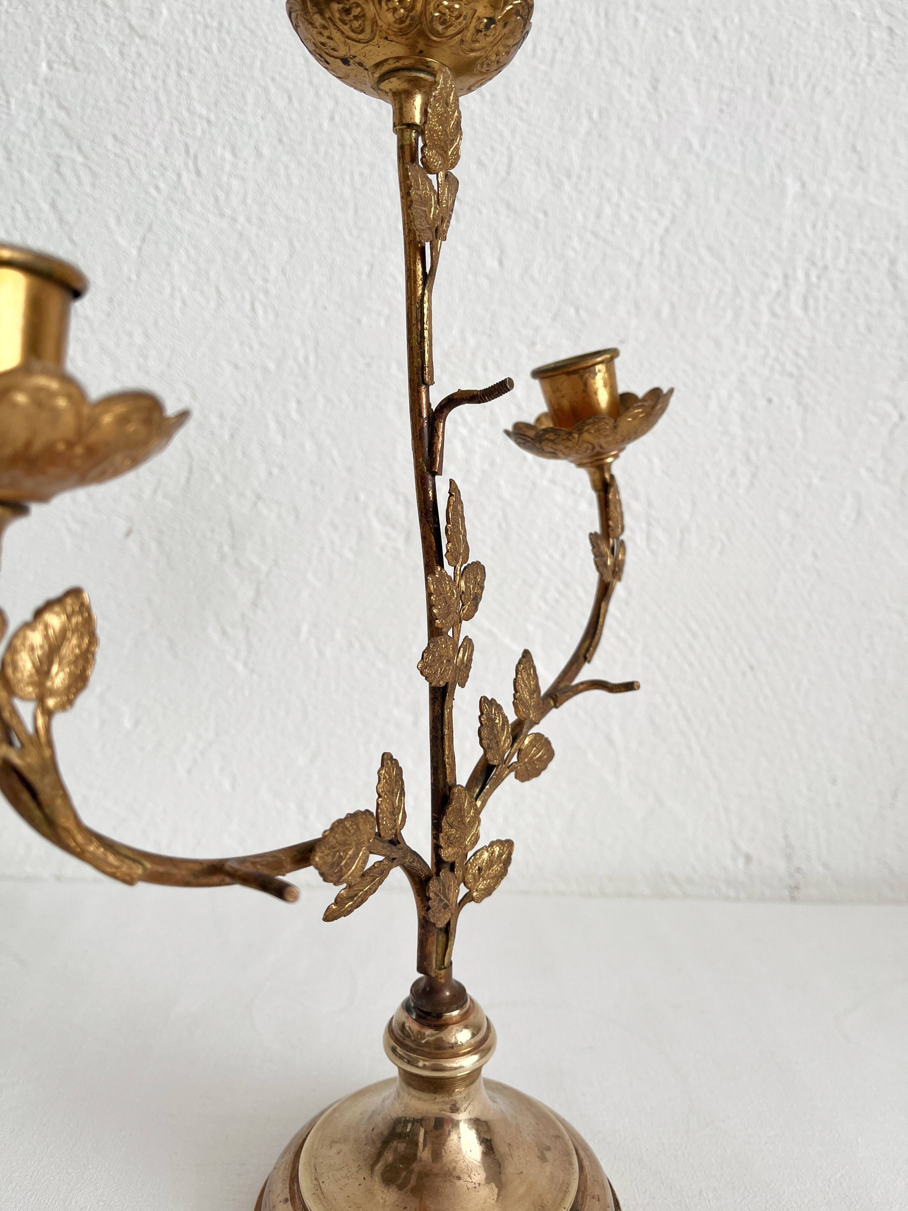 Antique bronze and brass candlestick with golden leaves