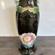 Antique ceramic vase by De Bruyn with floral decoration.