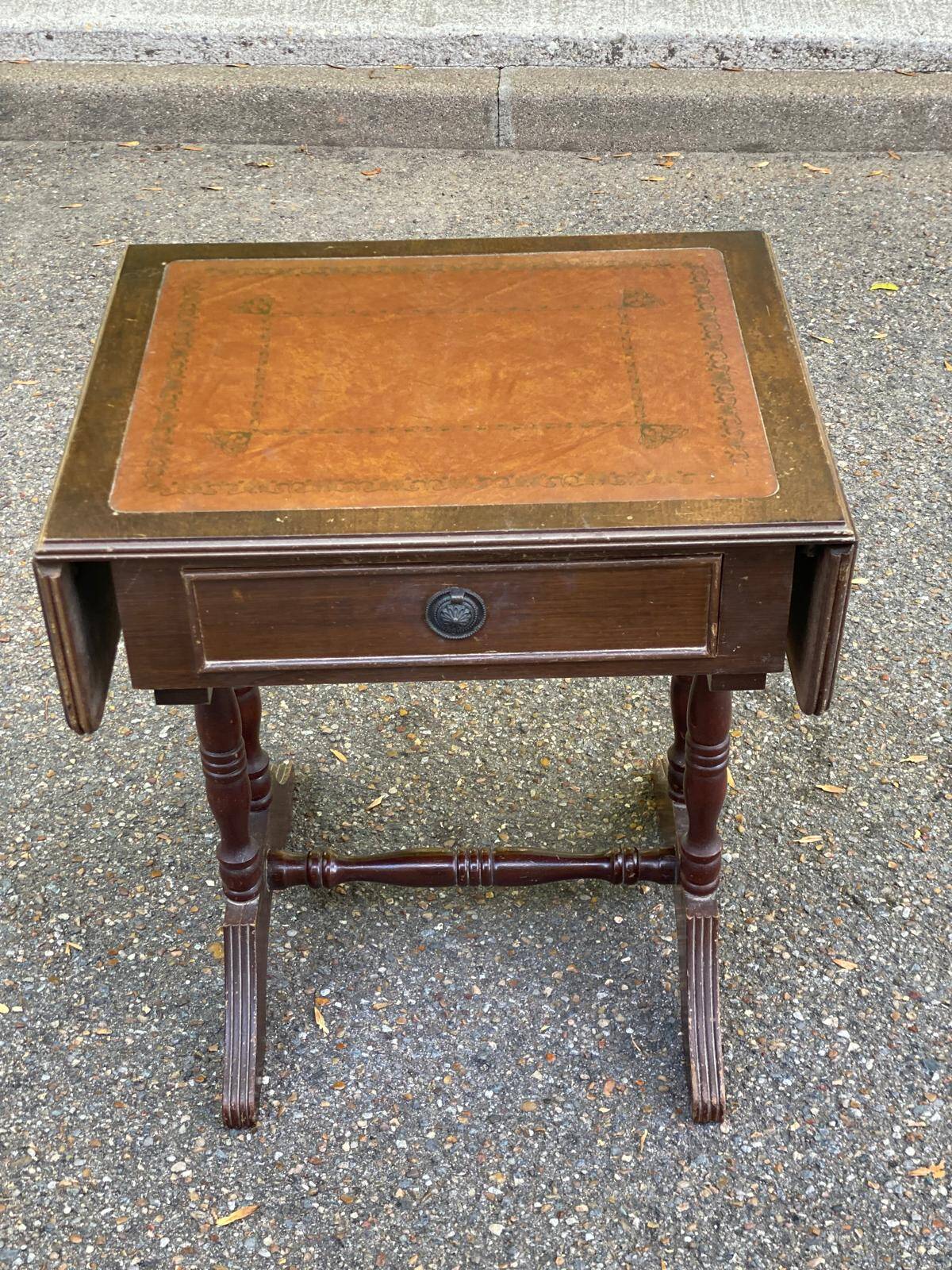 Small drop-leaf side table in English style with leather top & drawer.