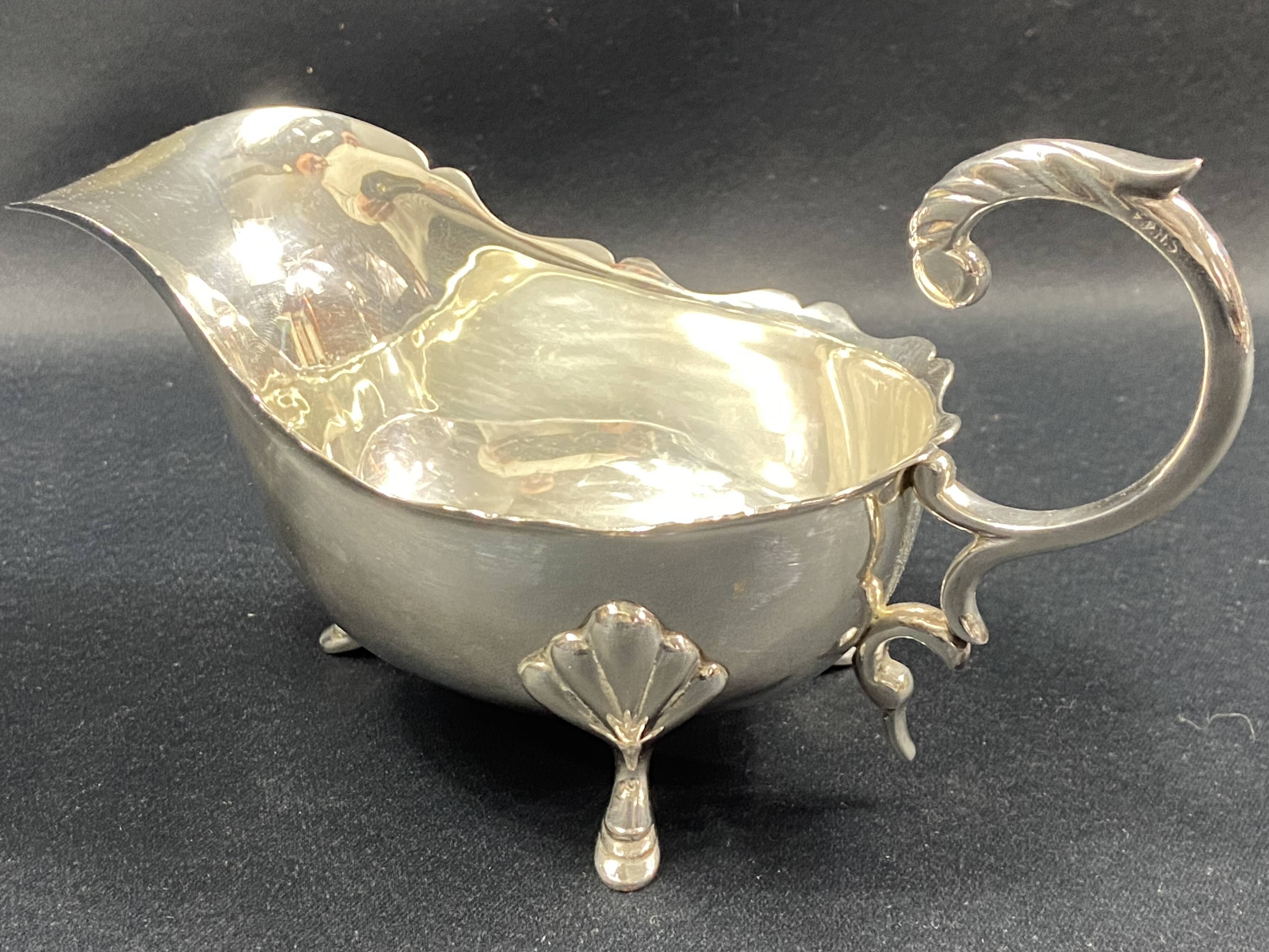 English George III style silver plated tripod sauce boat