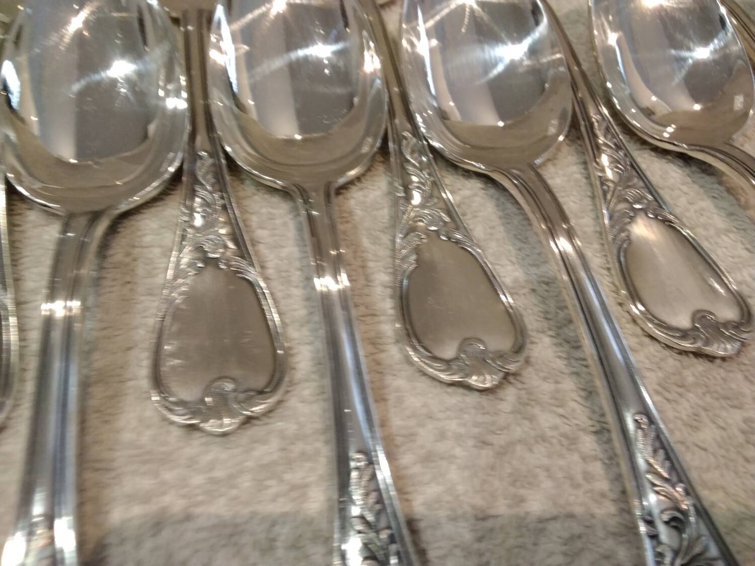 12 silver-plated metal soup spoons, Ercuis Dubarry model.