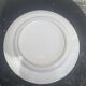 Two earthenware dishes, one hollow and one white cake dish with yellow border