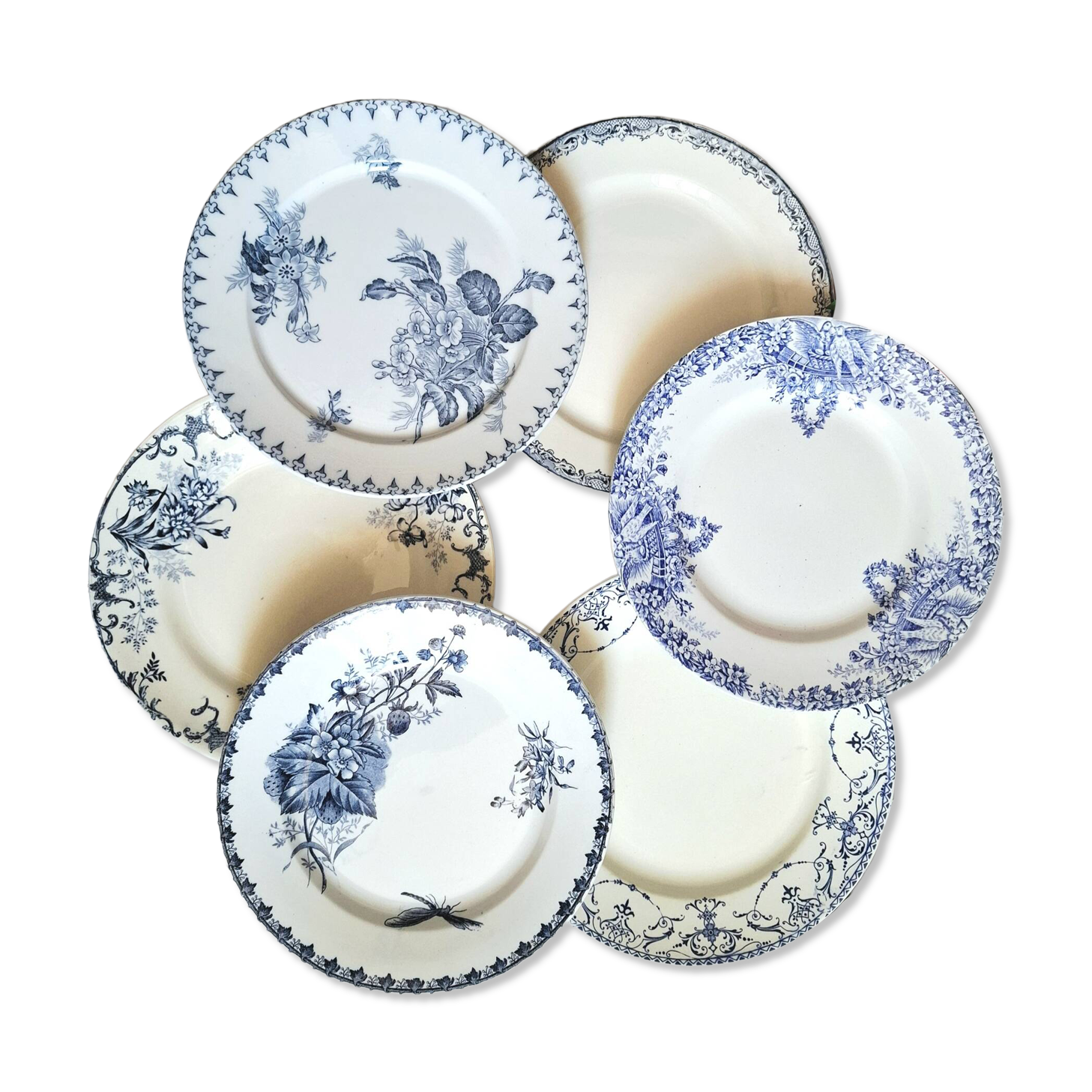 Old mismatched flat plates made of ironstone earthenware.