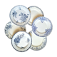 Old mismatched flat plates made of ironstone earthenware.