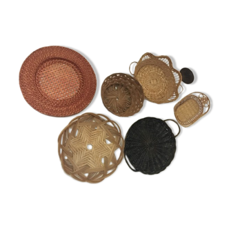 Wall composition of 7 wicker trays and baskets.