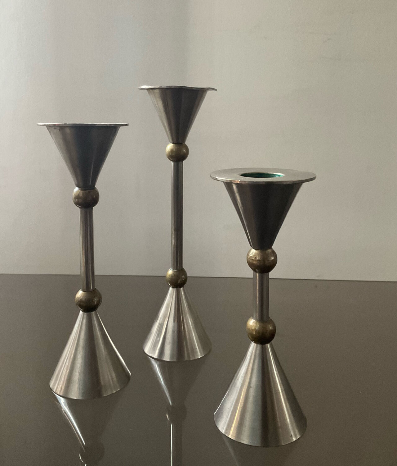 Trio of vintage metal and bronze candle holders