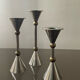 Trio of vintage metal and bronze candle holders