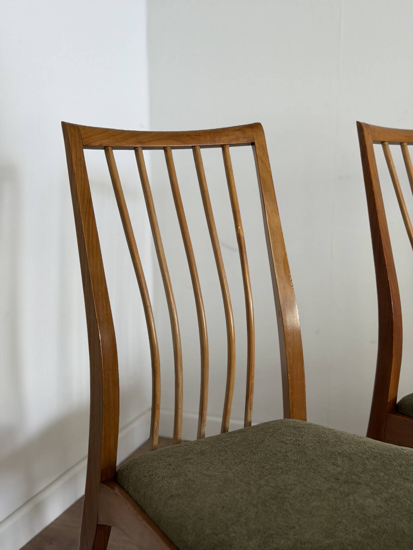 Scandinavian chairs with green velvet upholstery.