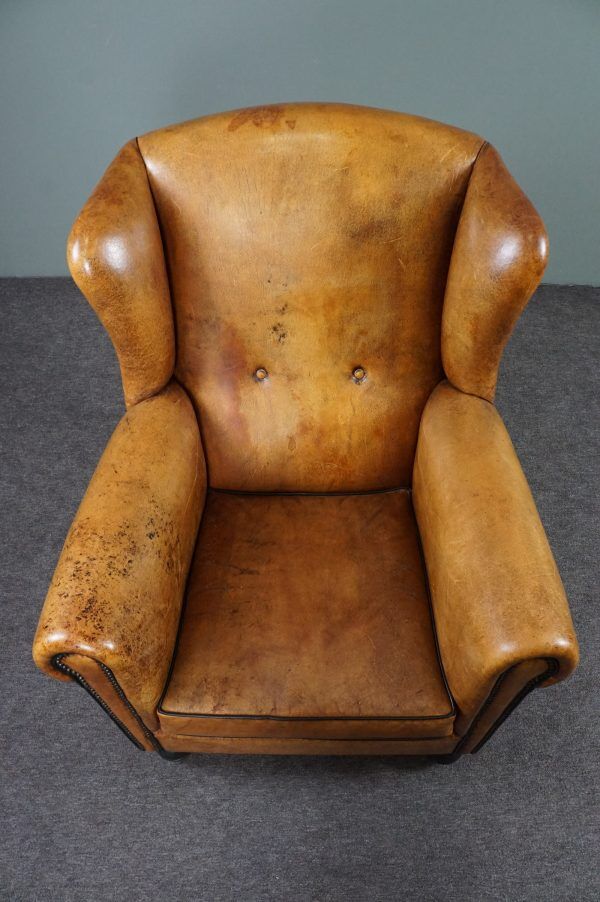 Antique armchair in patinated sheepskin