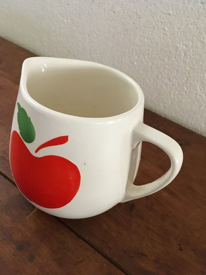 Vintage pitcher with apple decoration.