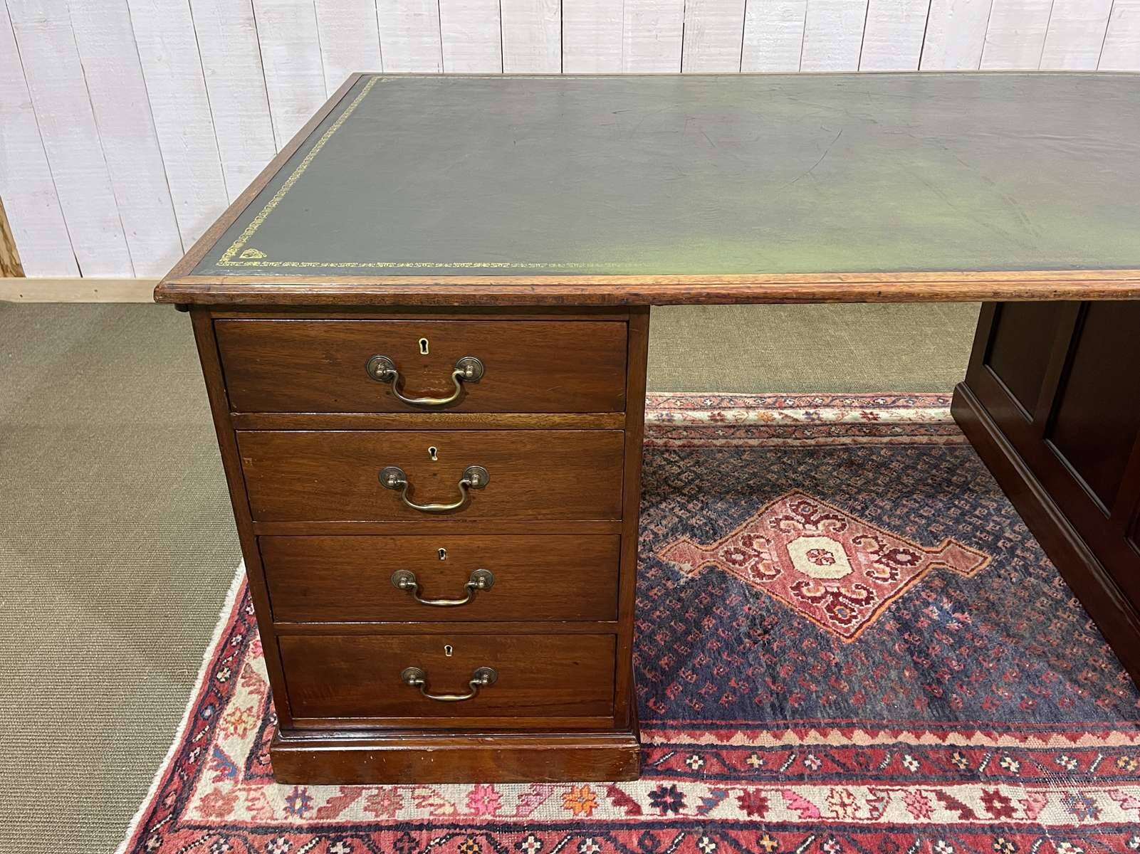 Large English flat desk in mahogany with leather top, early 20th century