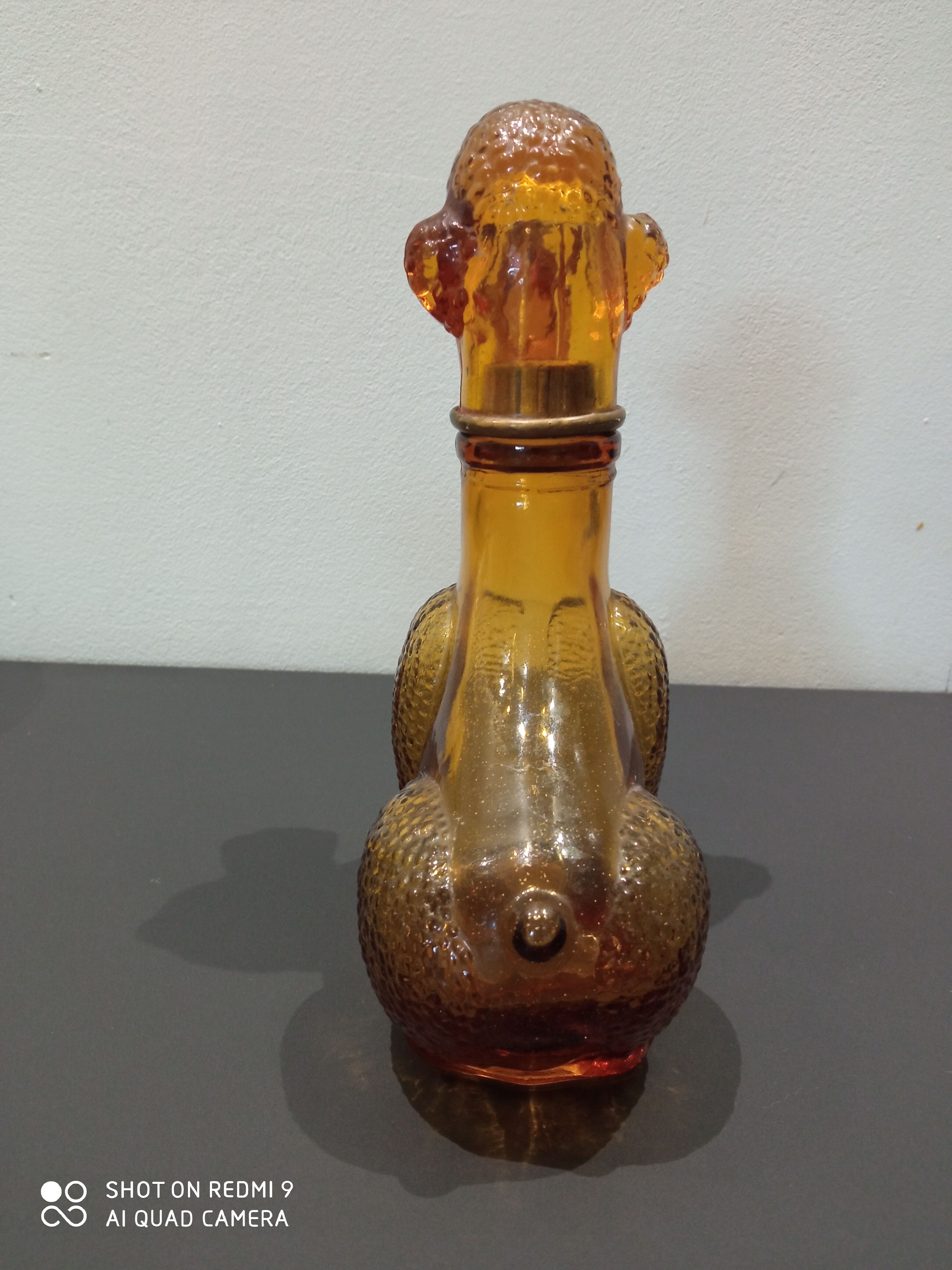 Old bottle in amber glass "poodle"