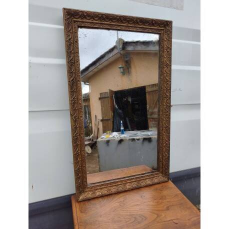 19th-century fireplace mirror in gilded wood and stucco.