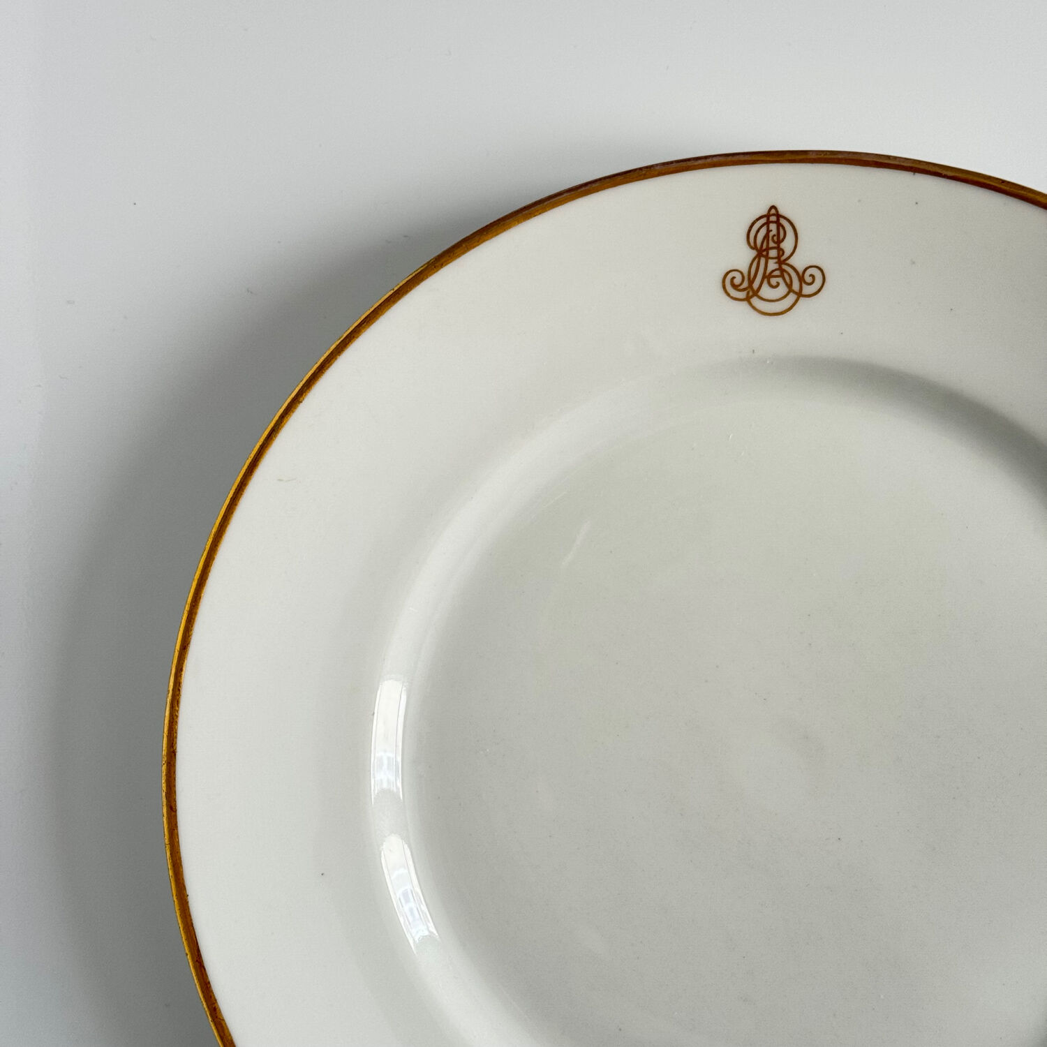 Set of monogrammed plates with gilt edges | E. Bourgeois | Late 19th century