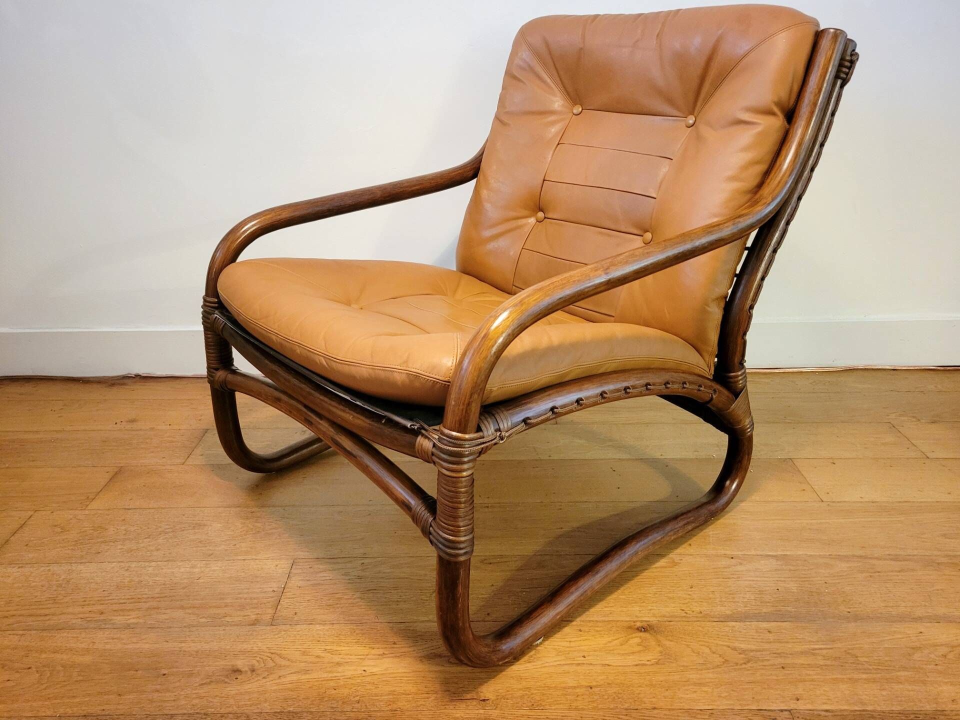 Vintage rattan armchair with leather cushions from 1970