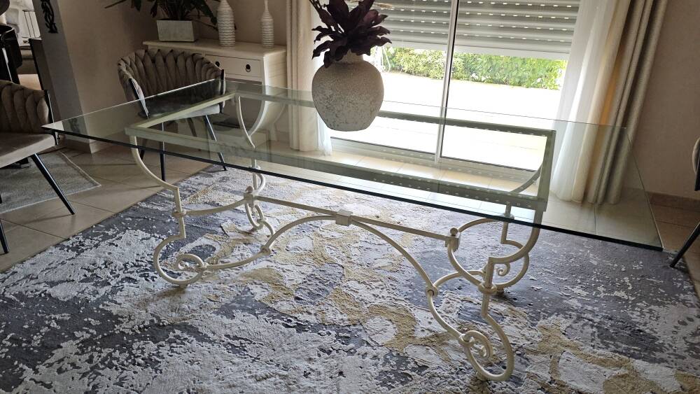 Wrought iron table by Roche Bobois, with a glass top.