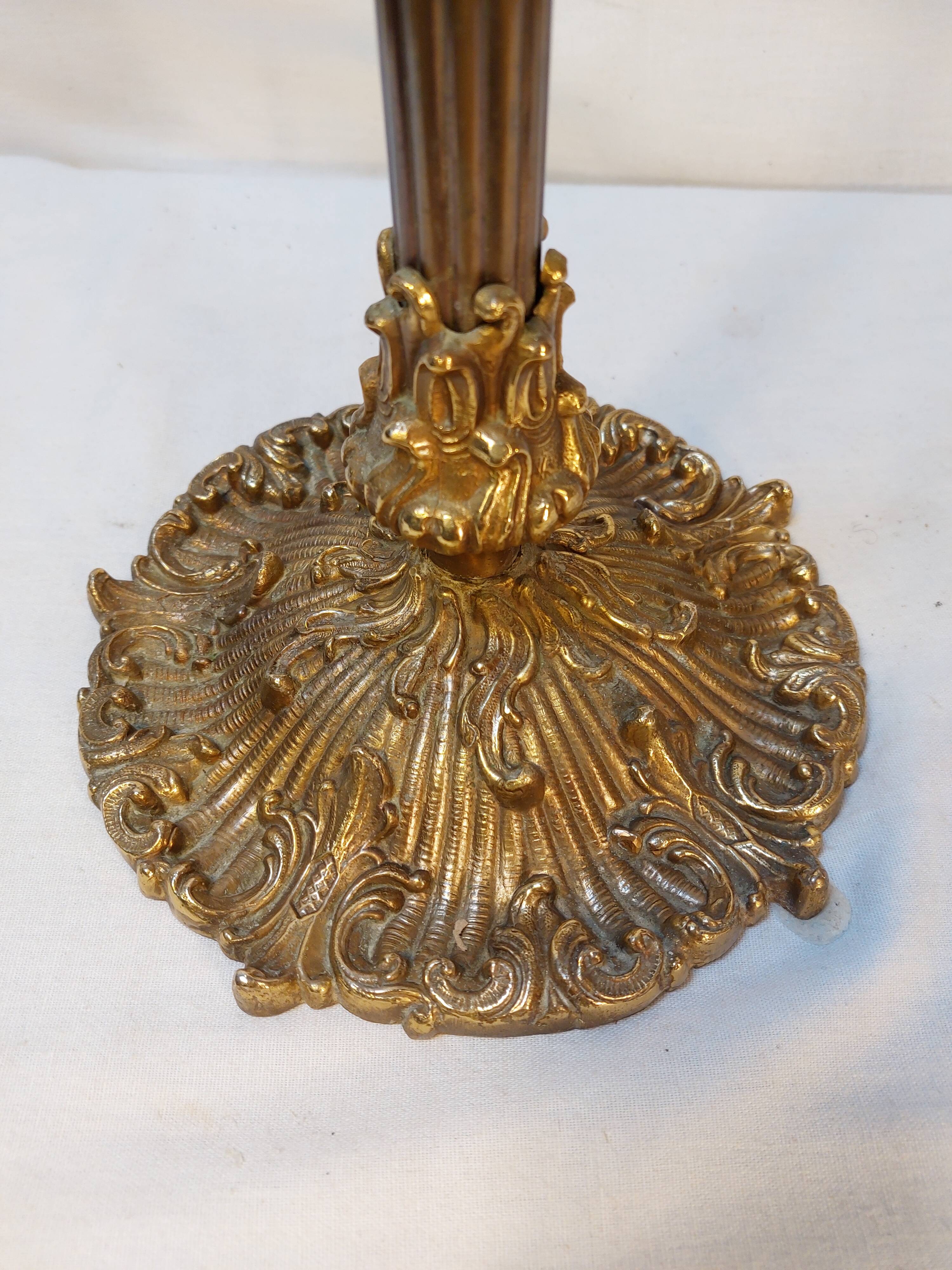 Old golden brass towel rack on baroque style foot