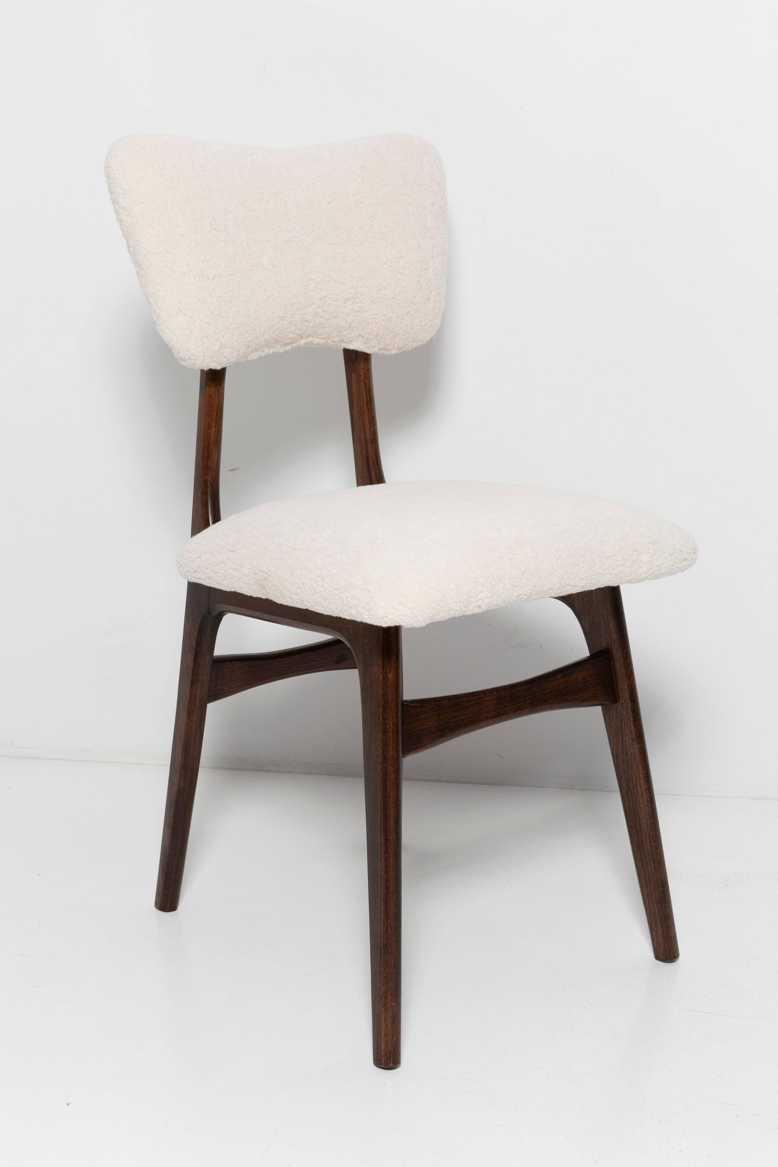 20th-century walnut and light cream boucle butterfly chair, Europe, 1960.
