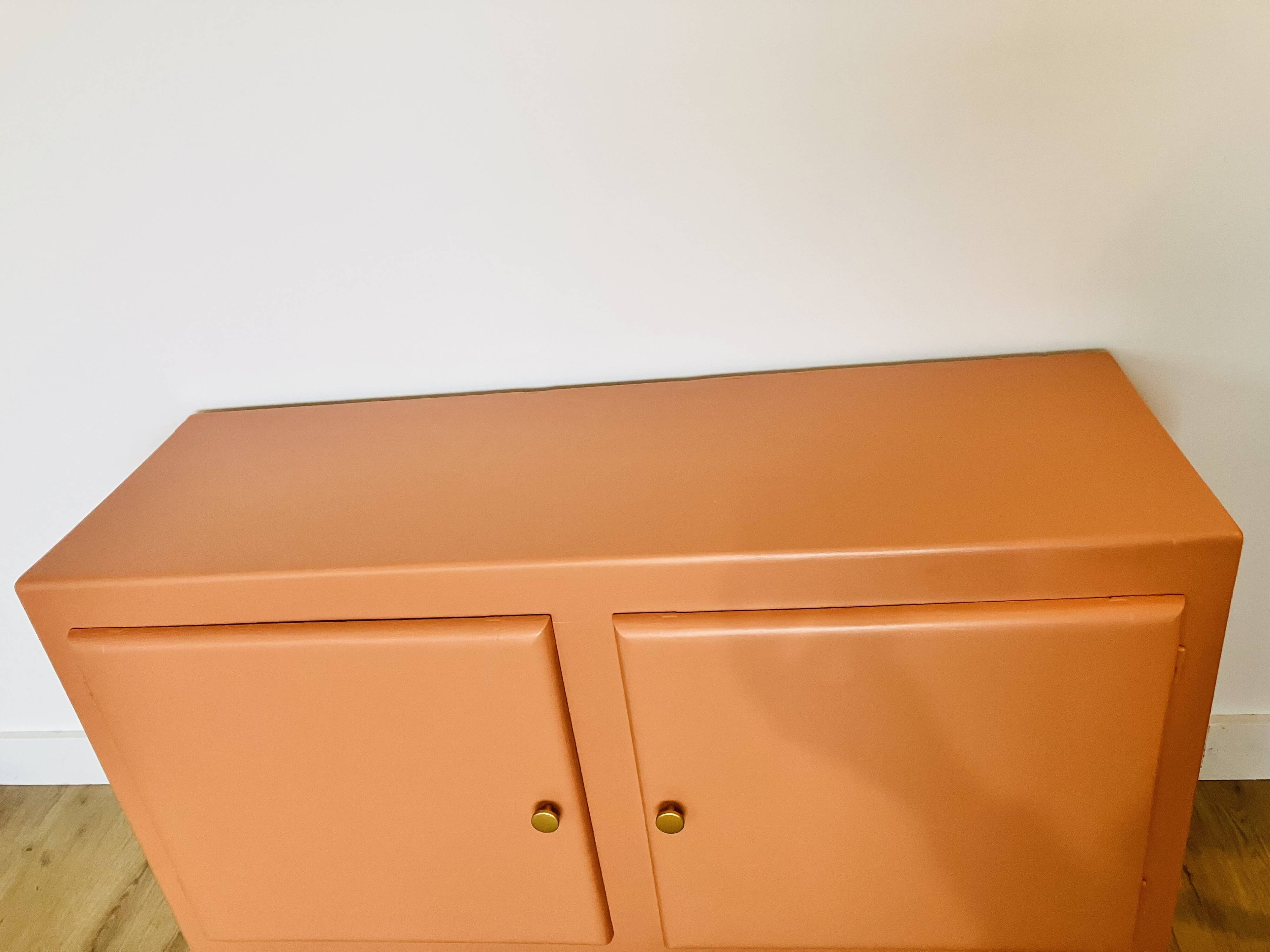 Terracotta painted wooden sideboard