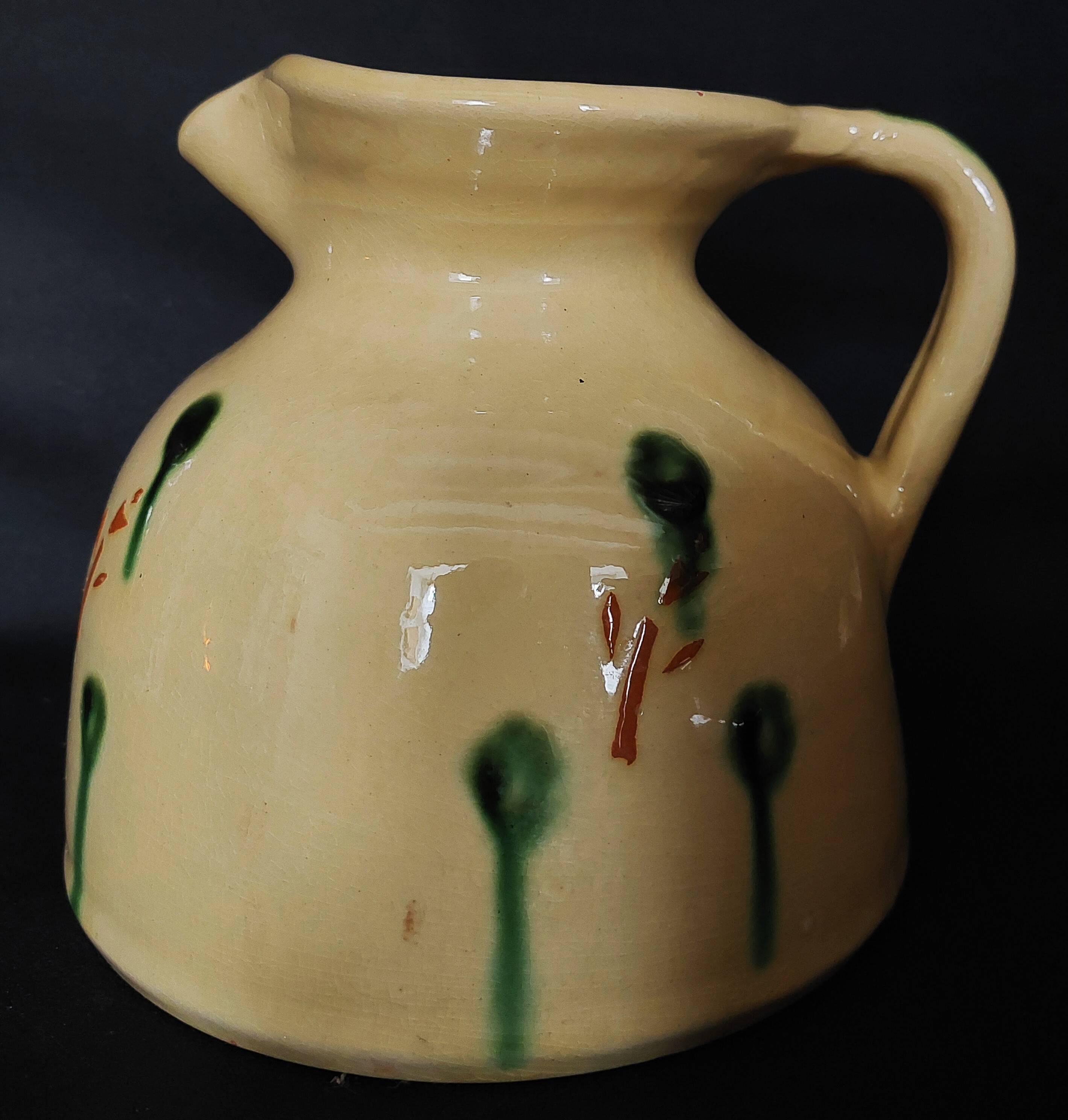 Vintage glazed terracotta ceramic jug from the 20th century.