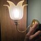 Frosted glass wall sconces and gilded brass in Art Deco style.