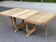 Art Deco dining table with a central pedestal, stripped in solid oak, with 2 extensions.