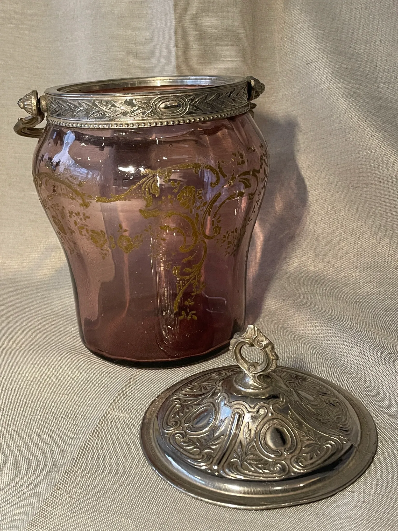 Purple glass biscuit barrel with painted gold arabesque decorations for cakes.
