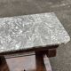 Mahogany console with grey marble top and lion paw feet.