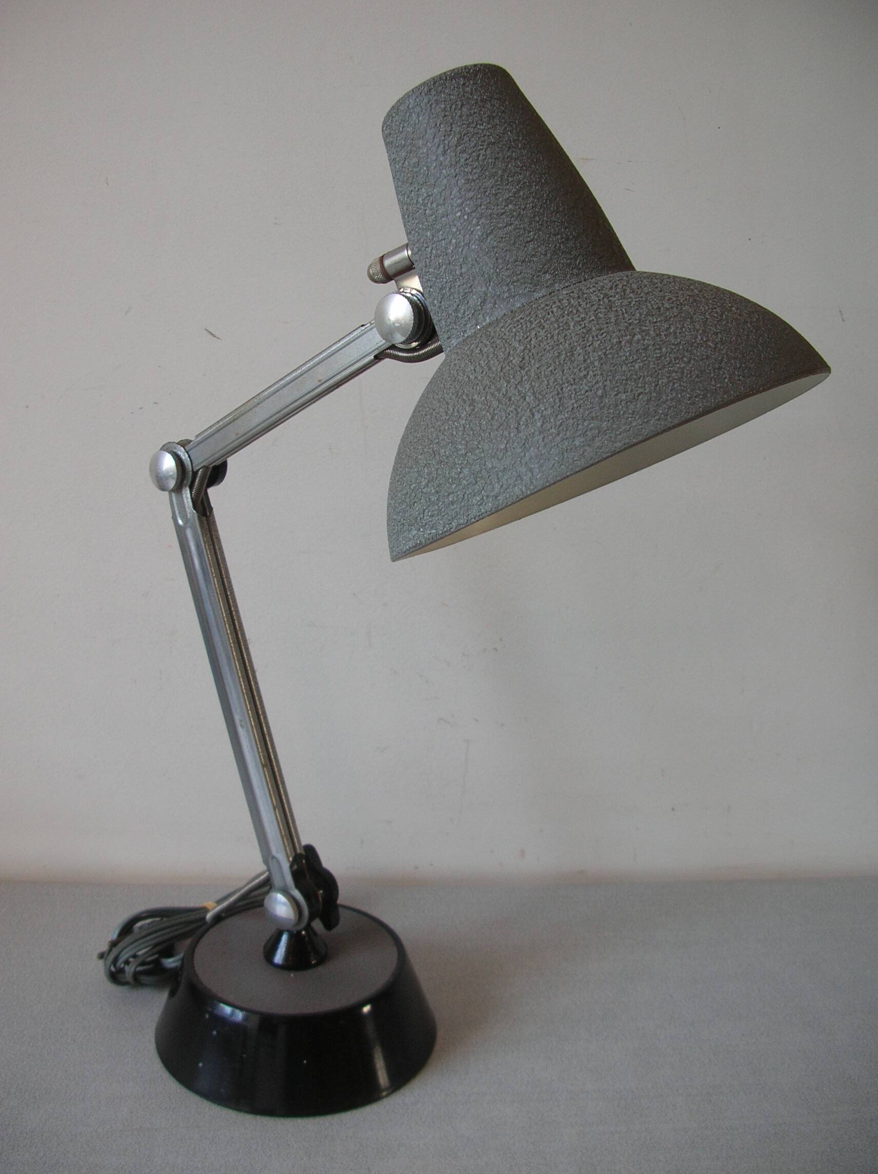 Super Chrome old articulated metal desk lamp on workshop decor base
