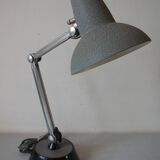 Super Chrome old articulated metal desk lamp on workshop decor base