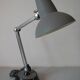 Super Chrome old articulated metal desk lamp on workshop decor base