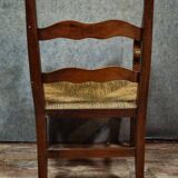 Empire armchair in solid walnut with woven straw seat.