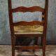 Empire armchair in solid walnut with woven straw seat.