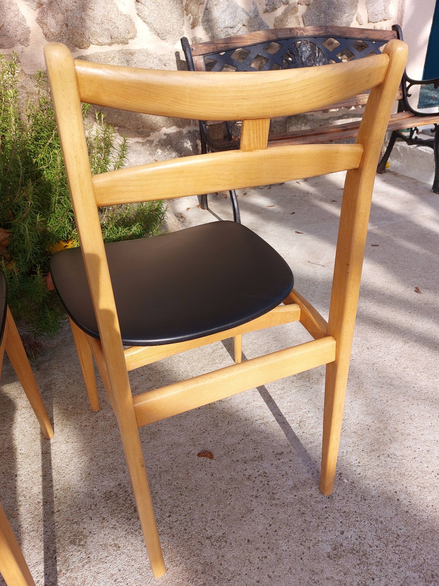 3 Scandinavian style chairs, light wood and black faux leather.