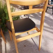 3 Scandinavian style chairs, light wood and black faux leather.